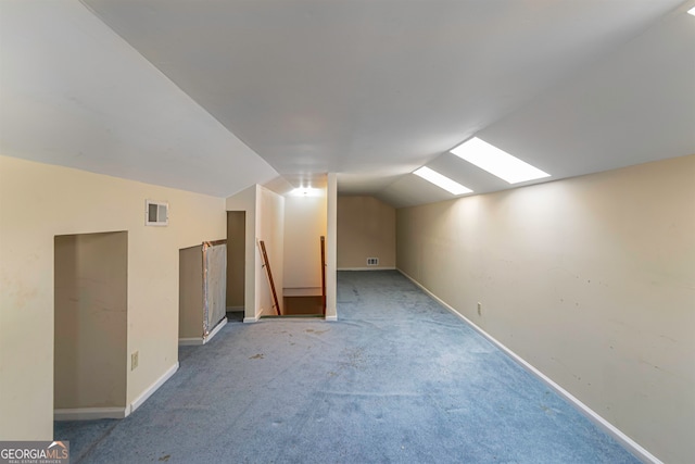 additional living space featuring light carpet and lofted ceiling