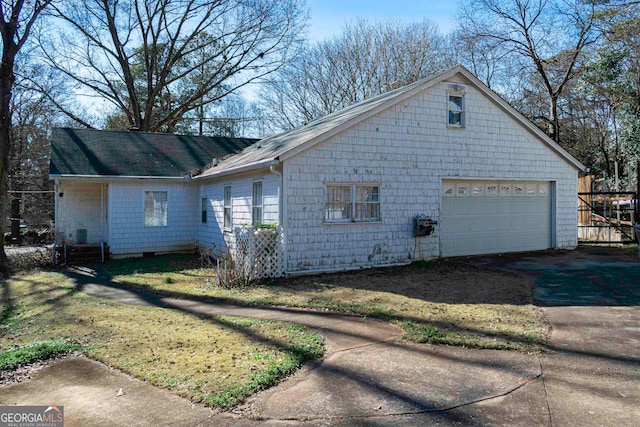 view of home's exterior with a lawn and a garage