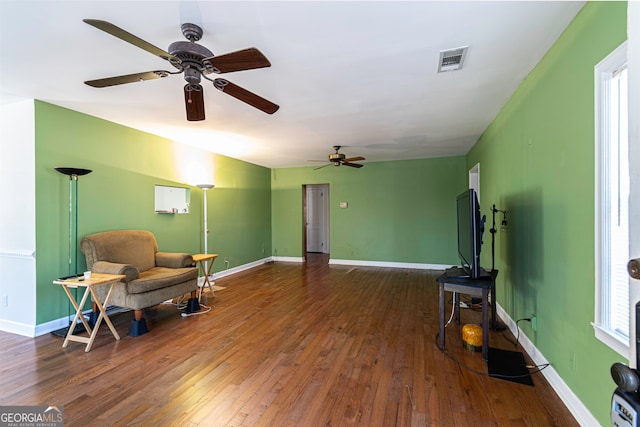 sitting room featuring ceiling fan and dark wood-type flooring