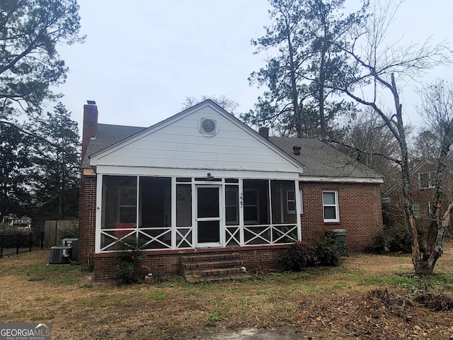 back of house featuring a sunroom and central AC unit