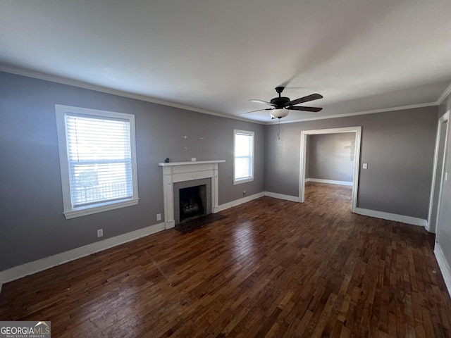 unfurnished living room featuring ceiling fan, dark hardwood / wood-style flooring, and ornamental molding