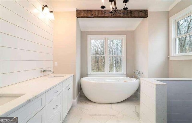 bathroom featuring a wealth of natural light, tile flooring, dual vanity, and an inviting chandelier