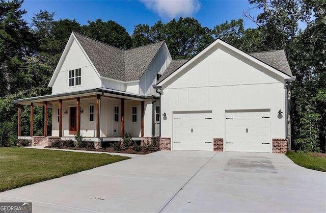 modern farmhouse style home with a porch, a front lawn, and a garage