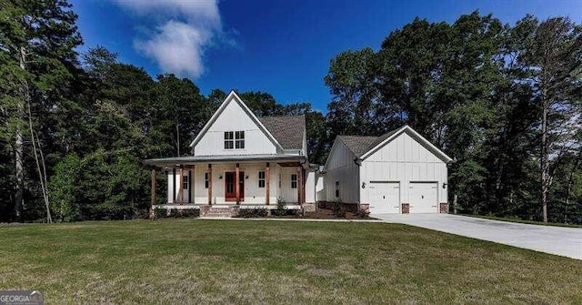 modern farmhouse with a front yard, a porch, and a garage