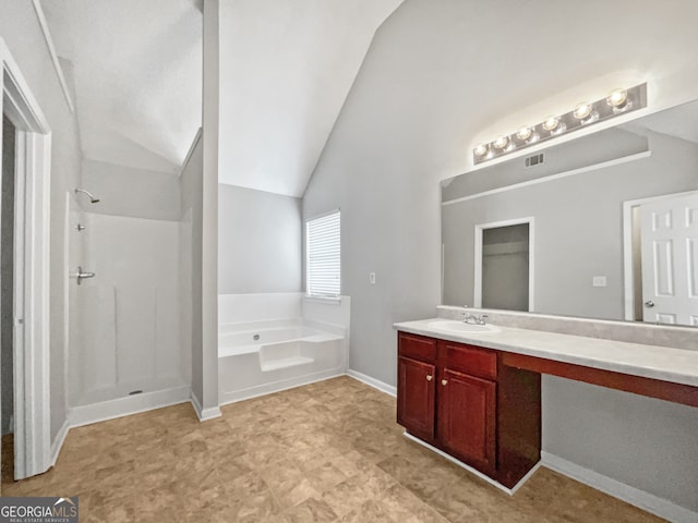 bathroom with vanity, separate shower and tub, and vaulted ceiling