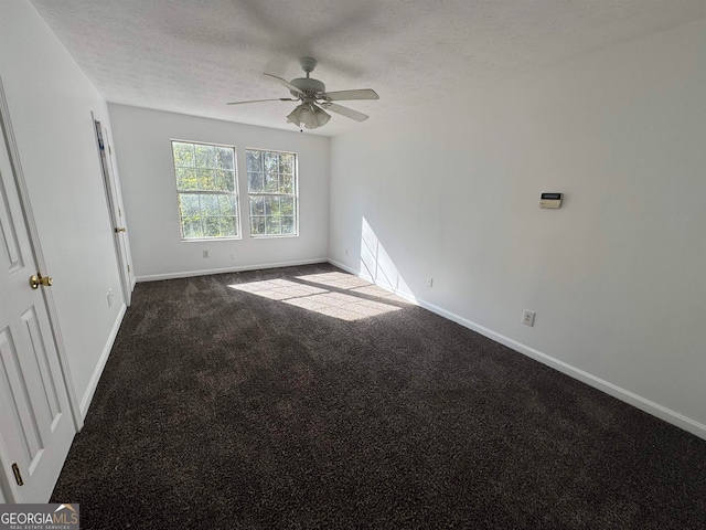 unfurnished room with a textured ceiling, ceiling fan, and dark colored carpet