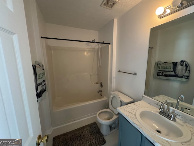 full bathroom featuring toilet, shower / bathing tub combination, a textured ceiling, and vanity