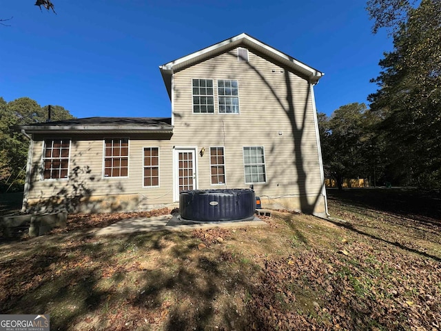 rear view of property with central AC unit