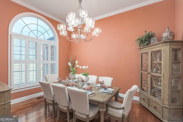 dining space featuring dark hardwood / wood-style floors, an inviting chandelier, and ornamental molding