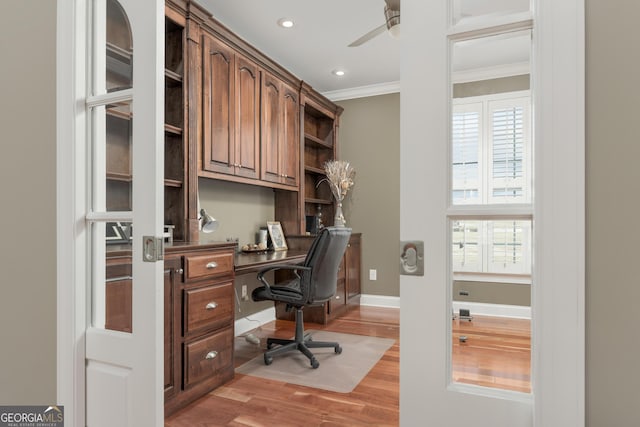 office space with ornamental molding, ceiling fan, a healthy amount of sunlight, and light hardwood / wood-style flooring