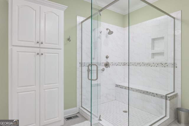 bathroom featuring crown molding, tile flooring, and an enclosed shower