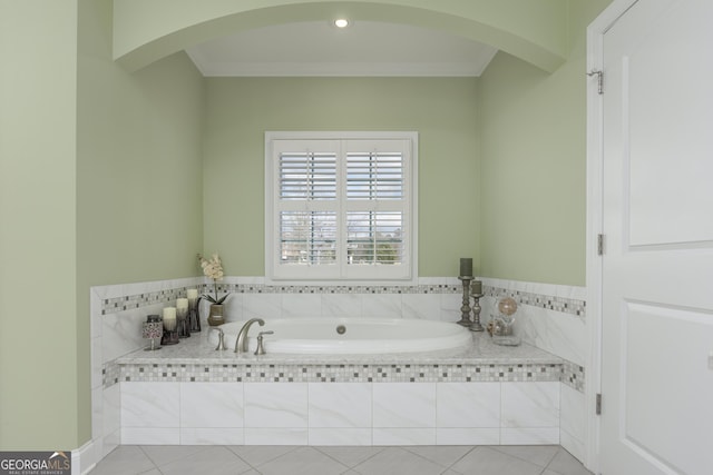 bathroom with tile floors, a relaxing tiled bath, and ornamental molding