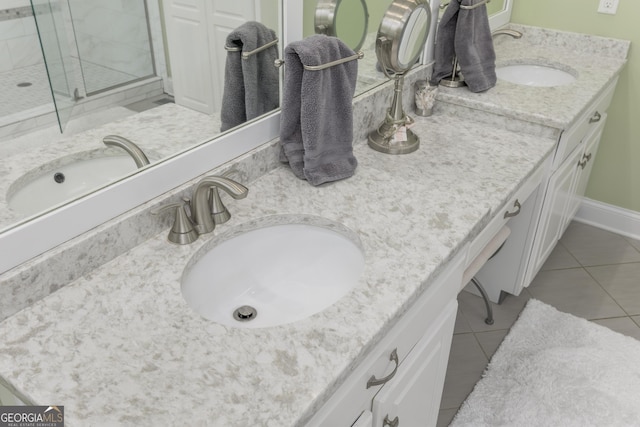 bathroom with tile flooring, an enclosed shower, and dual bowl vanity