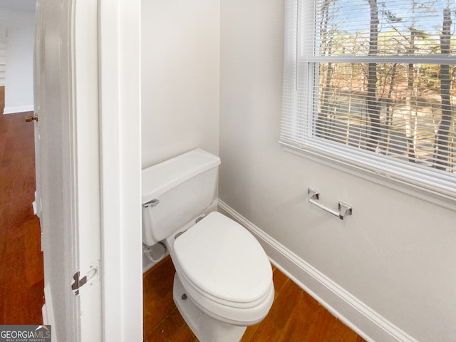 bathroom with toilet and wood-type flooring