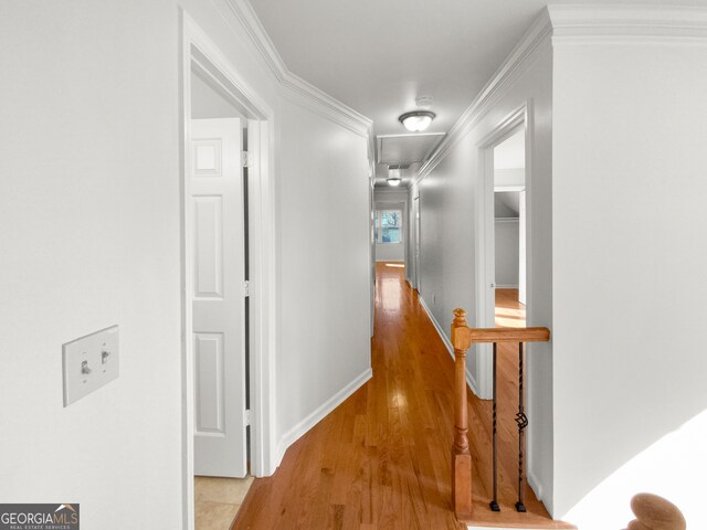 hall featuring ornamental molding and light wood-type flooring