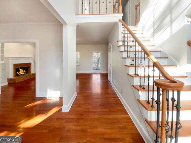 interior space with dark hardwood / wood-style flooring and ornamental molding