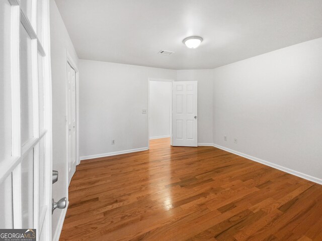 empty room with wood-type flooring