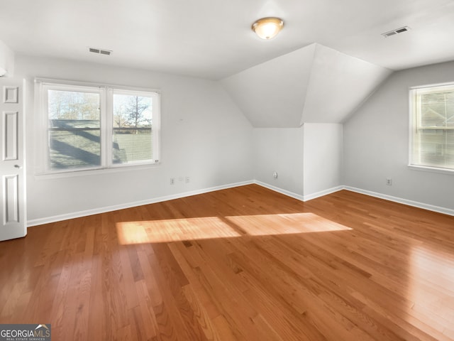 additional living space featuring hardwood / wood-style floors and lofted ceiling