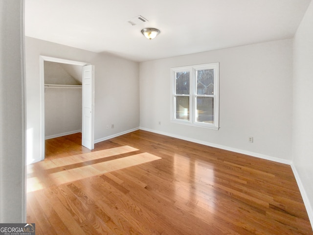 unfurnished bedroom featuring light hardwood / wood-style floors and a closet