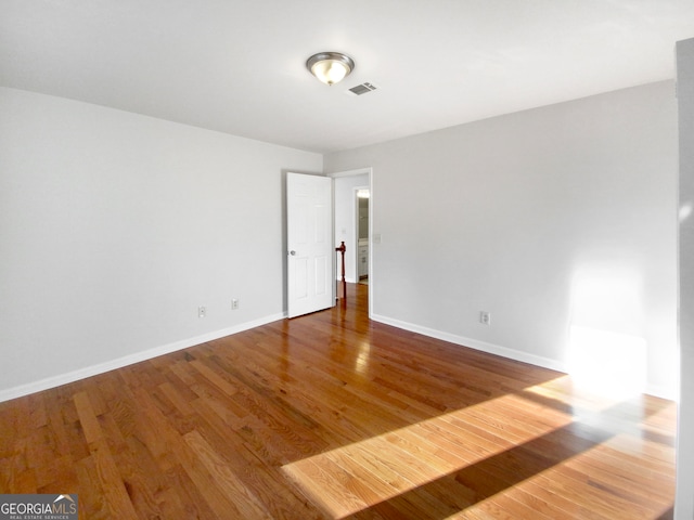 spare room with dark hardwood / wood-style flooring