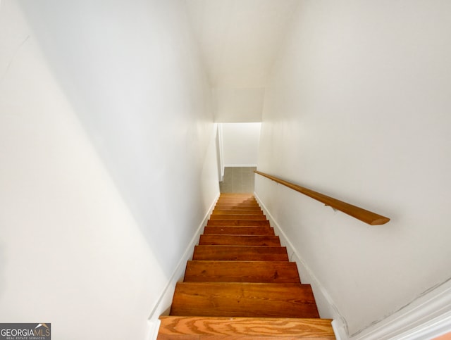 staircase featuring dark hardwood / wood-style flooring