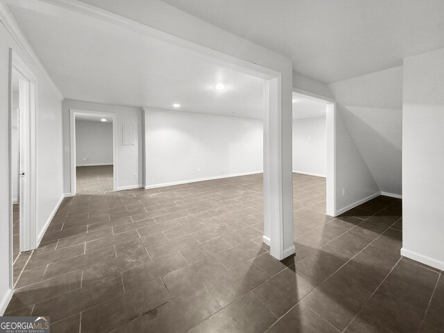 basement featuring dark tile floors