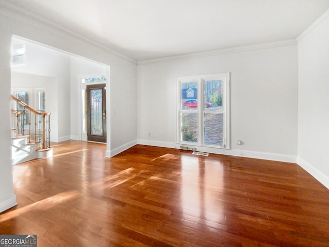 spare room with crown molding and dark hardwood / wood-style floors