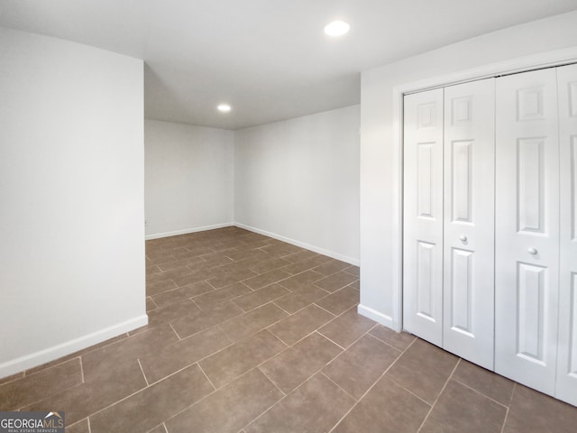 interior space featuring dark tile flooring