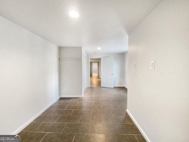 empty room with dark tile floors