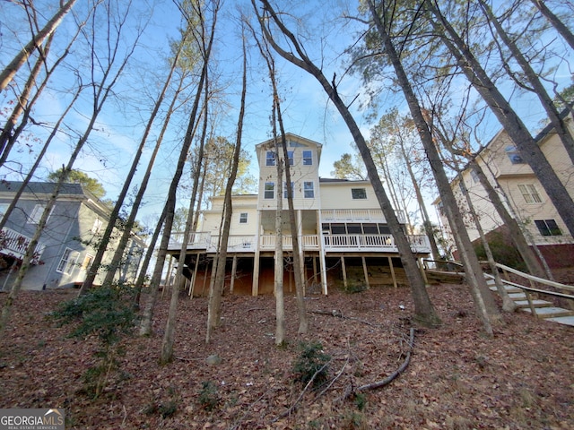 back of property with a wooden deck