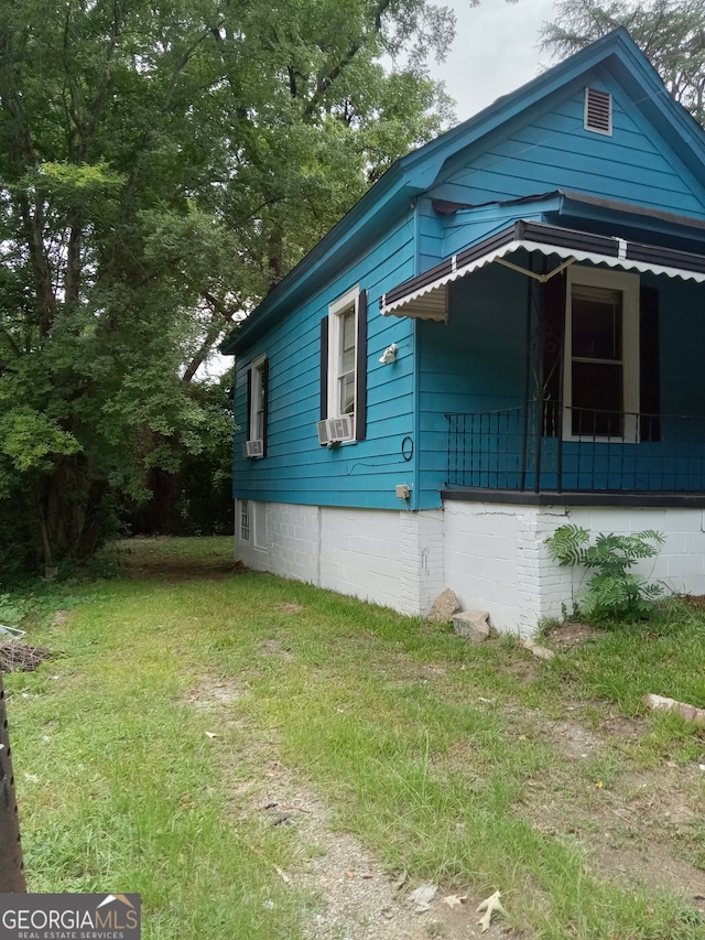 view of side of property with a lawn