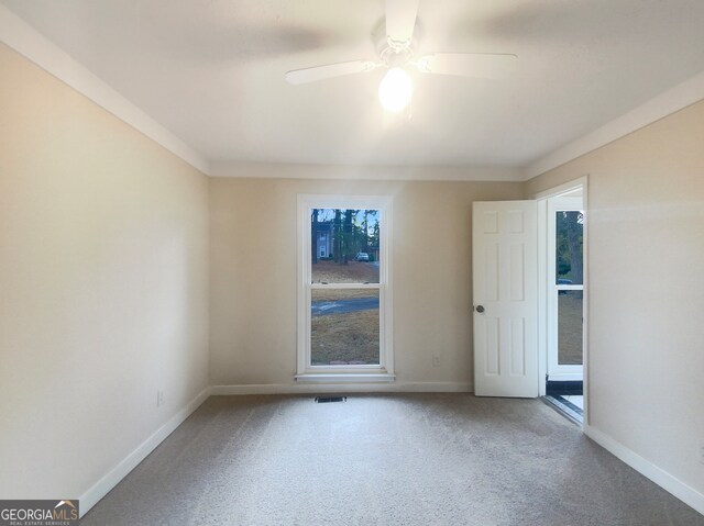 empty room with ceiling fan and light carpet