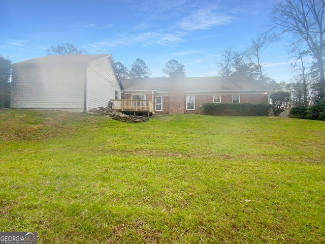 view of yard featuring a wooden deck