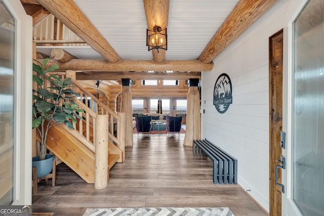 foyer entrance featuring a chandelier, beamed ceiling, and dark hardwood / wood-style floors