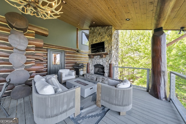 wooden terrace featuring an outdoor living space with a fireplace