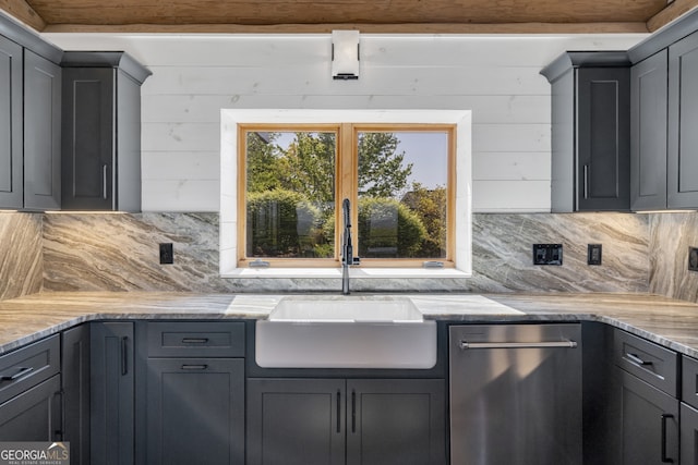 kitchen with backsplash, sink, light stone countertops, and stainless steel dishwasher