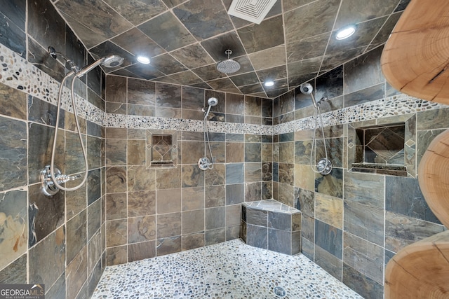 bathroom with tiled shower