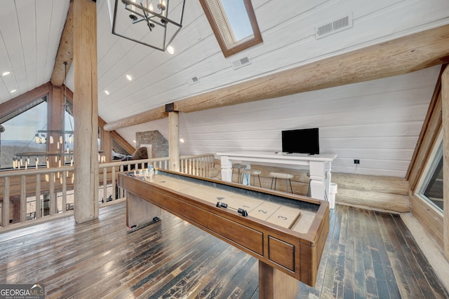 game room featuring vaulted ceiling with skylight, dark hardwood / wood-style floors, and a notable chandelier