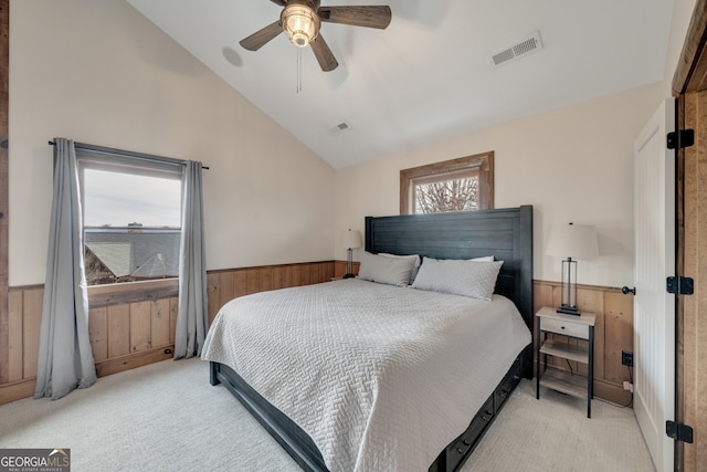 bedroom featuring light colored carpet, vaulted ceiling, and ceiling fan