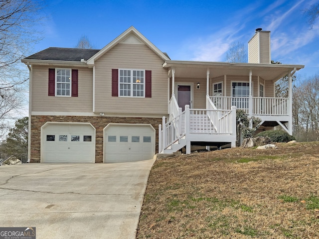 view of front of property featuring covered porch, a front yard, and a garage