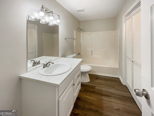 full bathroom featuring shower / bathing tub combination, toilet, wood-type flooring, and vanity