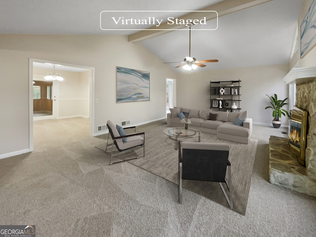 carpeted living room featuring plenty of natural light, a stone fireplace, vaulted ceiling with beams, and ceiling fan with notable chandelier