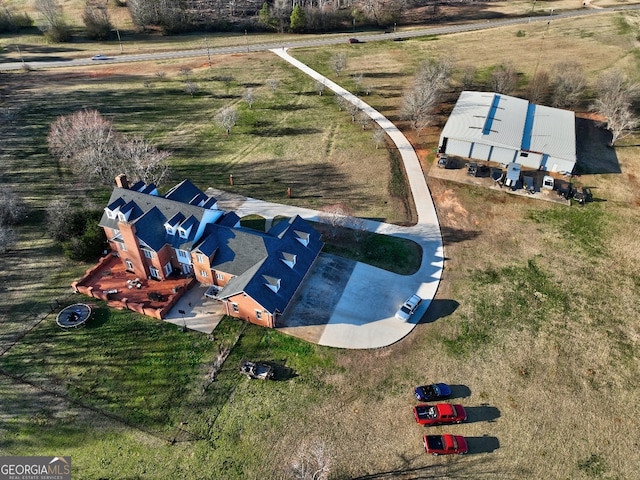 birds eye view of property with a rural view