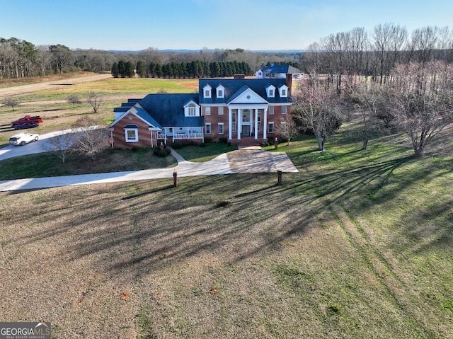 new england style home with a front lawn, french doors, and a rural view