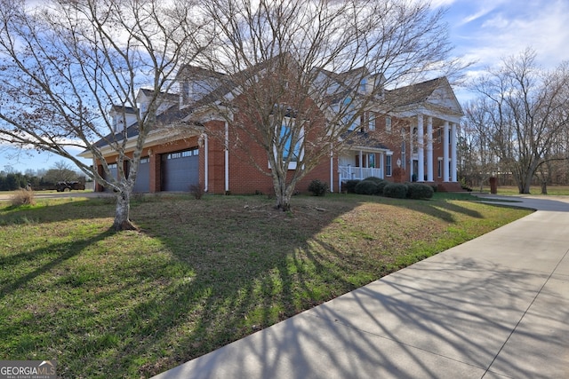 view of front of house featuring a front yard, covered porch, and a garage