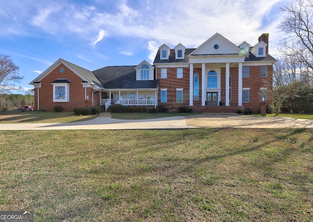 neoclassical / greek revival house with a front lawn and a porch