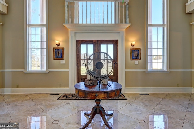 tiled entryway featuring a high ceiling