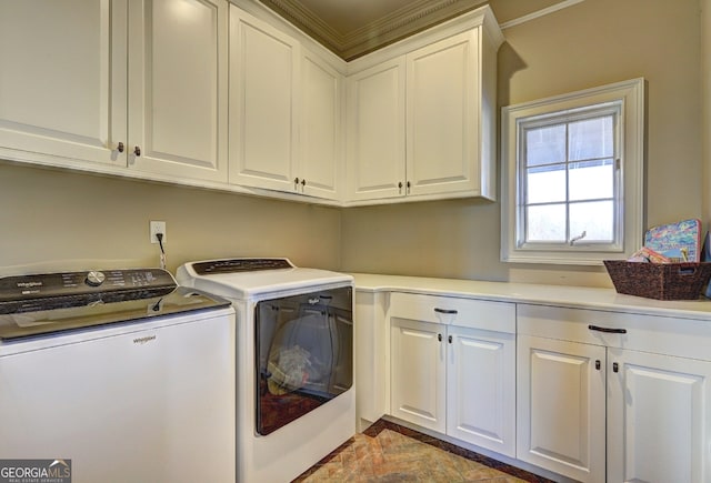 laundry area with washer and clothes dryer, cabinets, ornamental molding, and light tile floors