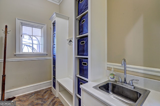 interior space featuring ornamental molding and sink