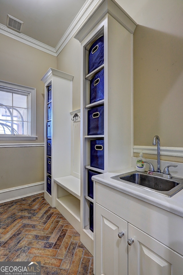 bathroom with crown molding and vanity